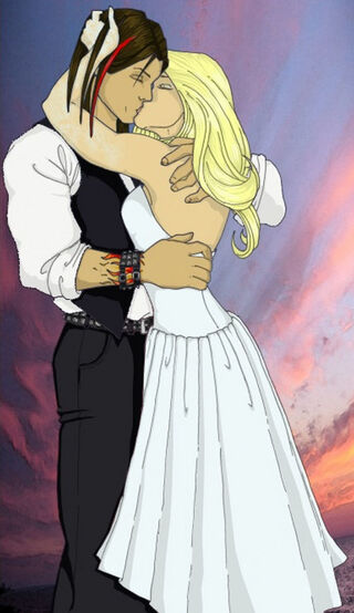 A couple embraces and kisses, dressed in formal attire against a colorful sunset backdrop.